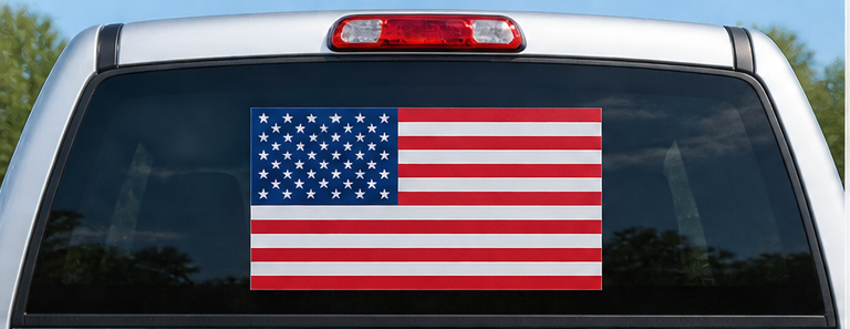 Illustrative American flag decal on pickup truck rear window