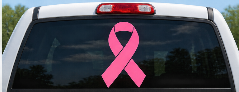 Illustrative pink ribbon decal on pickup truck rear window